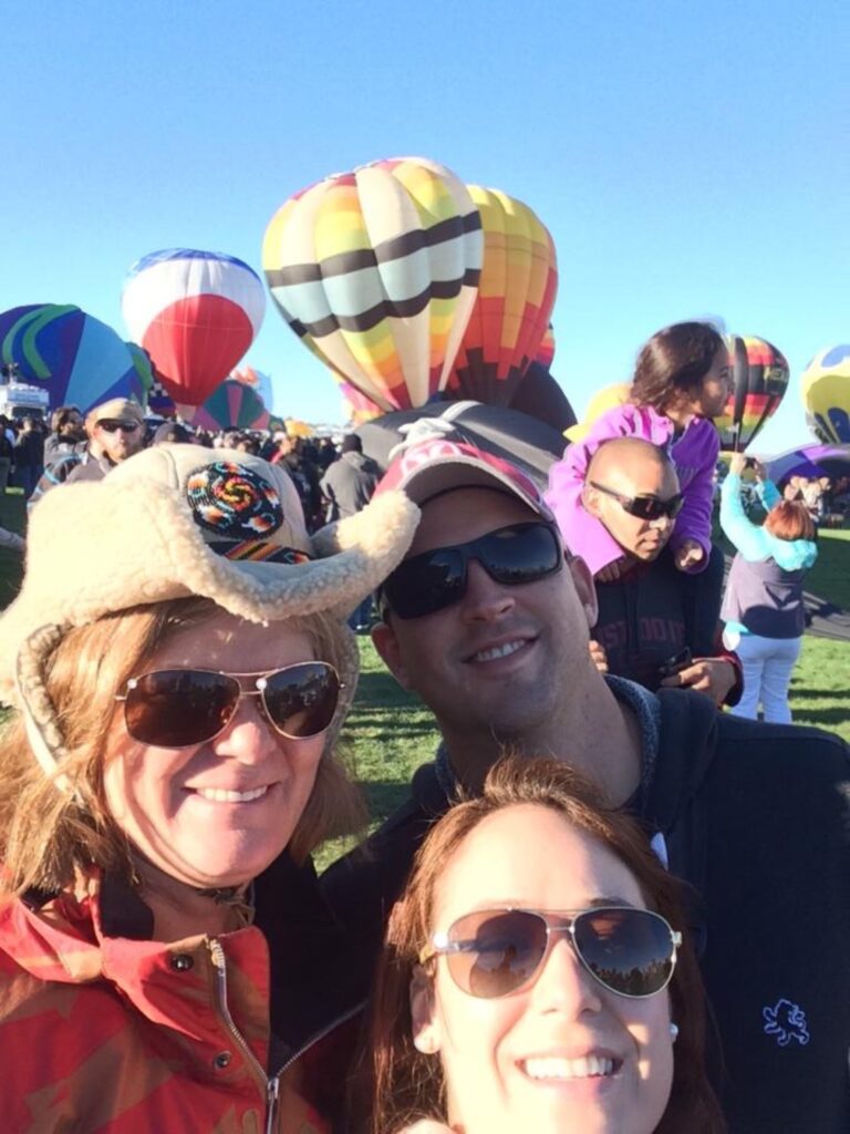 group selfie in front of hot air balloons