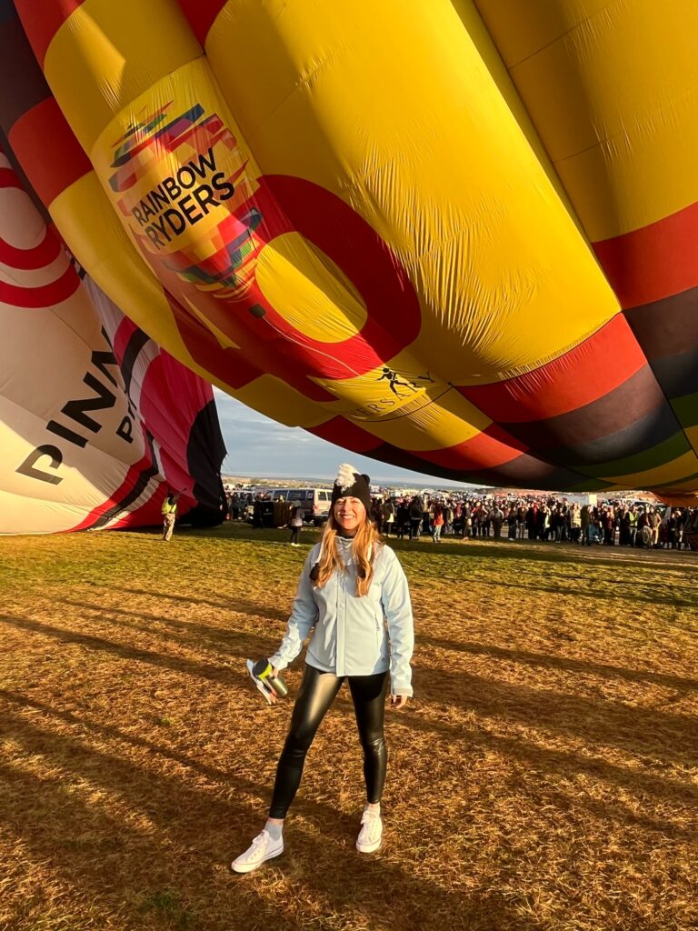 standing in front of a large balloon